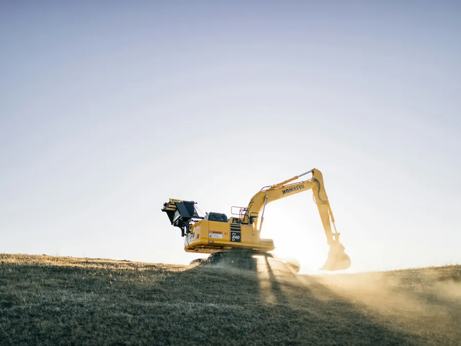 Excavator on a hillside — construction equipment leasing