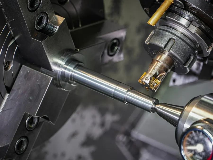 CNC lathe machining a metal part — manufacturing equipment leasing