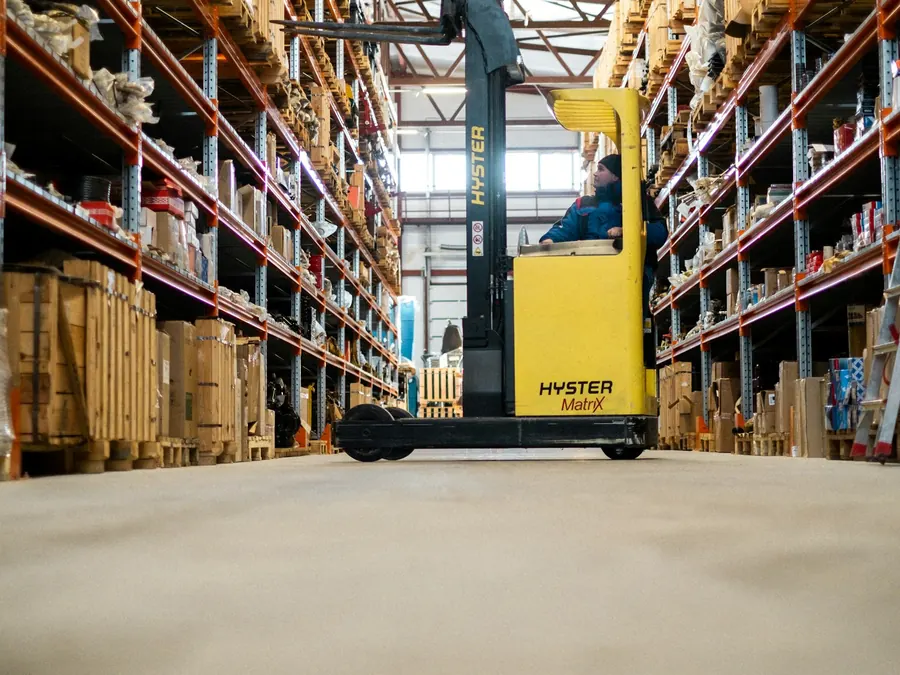 Forklift in a warehouse aisle — warehouse and material handling equipment leasing